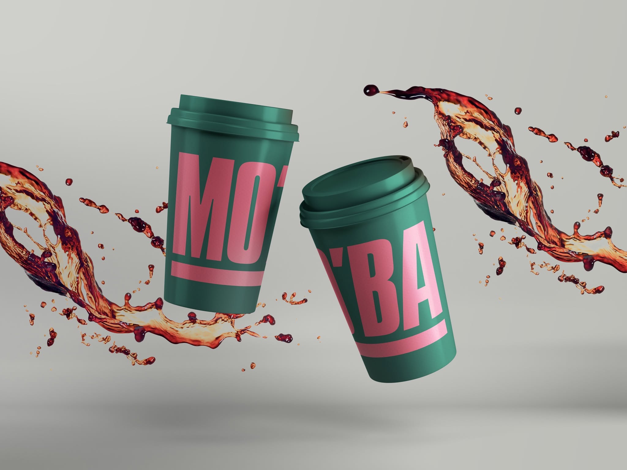 Two MO'BA cups tumbling through the air with coffee splashing around them, one printed with MO and the other with 'BA.