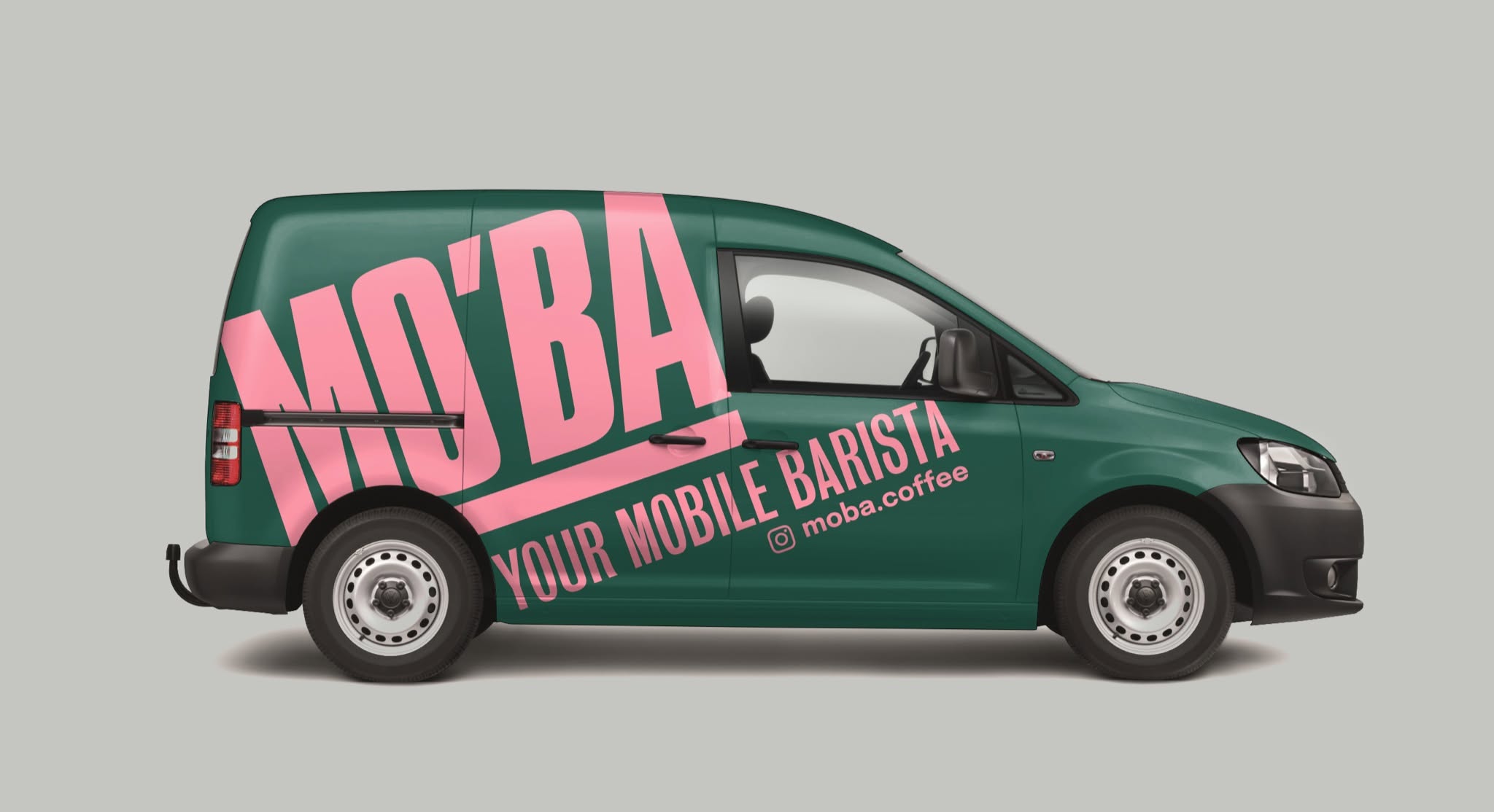 The MO'BA van livery — deep green bodywork with the bold pink MO'BA, Your Mobile Barista wordmark along the side panel.