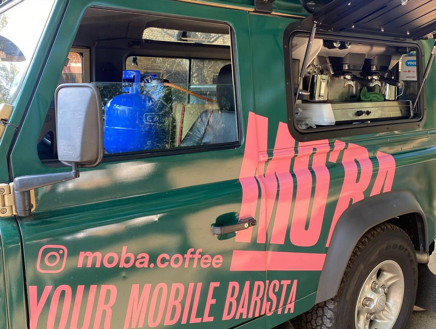 Close-up of the Defender's open service hatch, showing the built-in espresso machine.